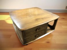 An Ercol stained elm Pandora's Box square storage coffee table, 80 cm W x 40 cm H.