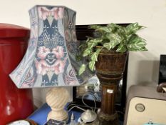A contemporary mahogany mirror, a pottery plant stand and a table lamp.