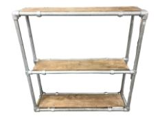 An industrial metal and pine three tier scaffold shelf,
