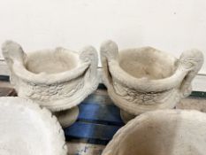 A pair of twin handled concrete garden planters, height 52 cm.