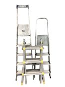 Two aluminum step ladders and a further folding ladder