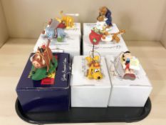 A group of Disney character models with boxes