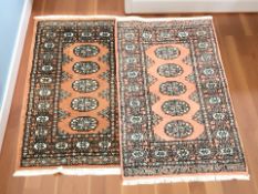 A near pair of Lahore Bokhara rugs, Pakistan, each approximately 99 cm x 67 cm.