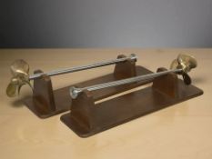 Two boat propellers on wooden plinths, length 46 cm.