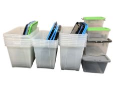 A quantity of plastic storage boxes with lids,
