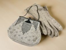 An early 20th century lady's bead work evening purse containing a pair of calfskin gloves.