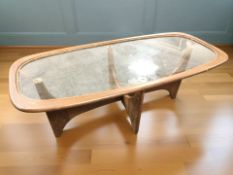 A 1970's G Plan teak and glass curved rectangular coffee table, 117 cm x 55 cm x 43 cm.