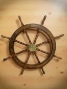 A teak and brass ship's wheel, diameter 107 cm.