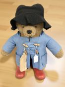 A Paddington Bear together with a painted cast iron door stop in the form of a man and dog.