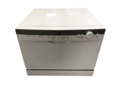 An Indesit table top dish washer