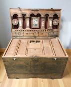 An oriental carved camphor wood and brass mounted blanket box, with compartmentalised interior,