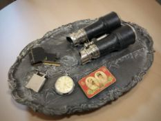 An embossed oval metal platter depicting The Last Supper, Ingersoll Triumph pocket watch,