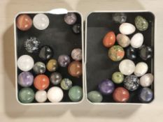 A group of polished hardstone and semi precious marbles, egg ornaments.