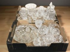 A group of crystal drinking glasses, two decanters with stoppers, fruit bowls, etc.