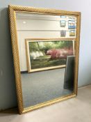 A modern gilt and bevelled overmantel mirror with ropework frame, 154 cm x 116 cm.