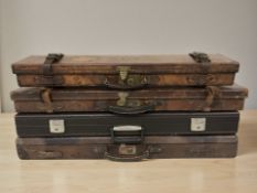 Two antique stitched chestnut brown leather shotgun cases, one stamped with the initials F.S.C.U.