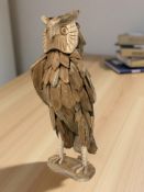 A rustic wooden owl statue,