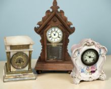 A ceramic mantel clock, an onyx clock and a further carved wooden mantel clock, tallest 64 cm.