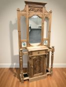 A reproduction carved pine mirror back and tiled hall stand, 94 cm x 37 cm x 204 cm.