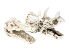 Two replica composition dinosaur skulls, t-rex and triceratops, longest 17 cm.