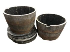 A pair of coopered oak barrel planters, diameter 66 cm, and six barrel lids.