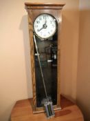 A National Recorder Company Limited clocking in clock in oak case, with pendulum,