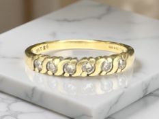 An 18ct gold six stone diamond ring, size O CONDITION REPORT: 2.