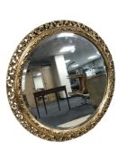 A modern ornate gilt circular mirror, diameter 62 cm.