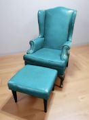 A 20th century wingback armchair and matching footstool upholstered in turquoise faux leather,