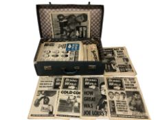 A vintage suitcase containing Boxing World publications