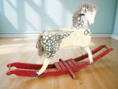A 20th century painted wooden rocking horse, length 190 cm.