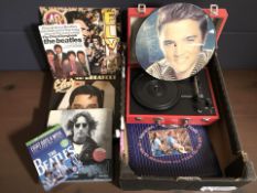 A group of The Beatles and Elvis Presley collectibles, a reproduction portable record player,