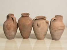 Four antique terracotta vases and jugs, tallest 28 cm.