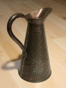 An Arts and Crafts copper jug, height 29 cm.