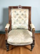 A Victorian library armchair in deep buttoned satin upholstery.