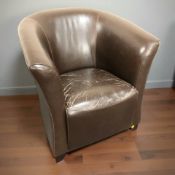 A contemporary stitched leather tub armchair.