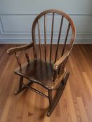 A child's spindle back rocking chair.