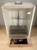 A set of balance scales in glazed painted case, height 39 cm.