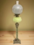 An onyx and gilt metal oil lamp with vaseline glass reservoir and etched clear glass shade,