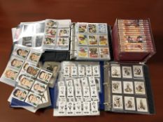 John Wayne collectibles including a large quantity of trading cards and a DVD box set.