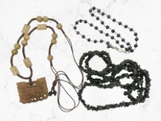 A Chinese mottled brown jade necklace together with Lapis necklace and one other black stone
