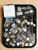 A collection of enameled badges, various coins, lighters including Ronson, wristwatches,