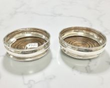 A pair of Elizabeth II silver and beech glass coasters, London 1971, diameter 8.5cm.