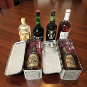 A group of bottles of alcohol including two bottles Chivas Regal scotch whisky, in tins,