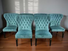 A set of six contemporary high backed chairs upholstered in deep buttoned turquoise fabric,