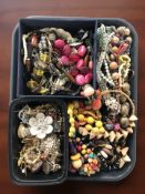 A collection of costume bead necklaces, brooches, etc.