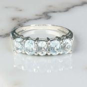 A 9ct white gold five stone blue topaz ring,