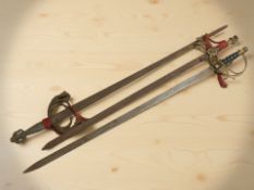 Three reproduction swords.
