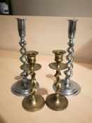 A pair of chrome barley twist candlesticks, height 25 cm, and a similar brass pair.