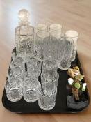 A group of crystal tumblers and highball glasses, a decanter and a Murano glass clown.